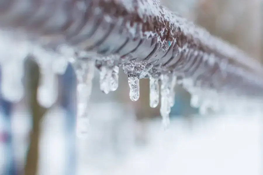 Icicles hanging from a frozen supply pipe during a hard North Texas freeze