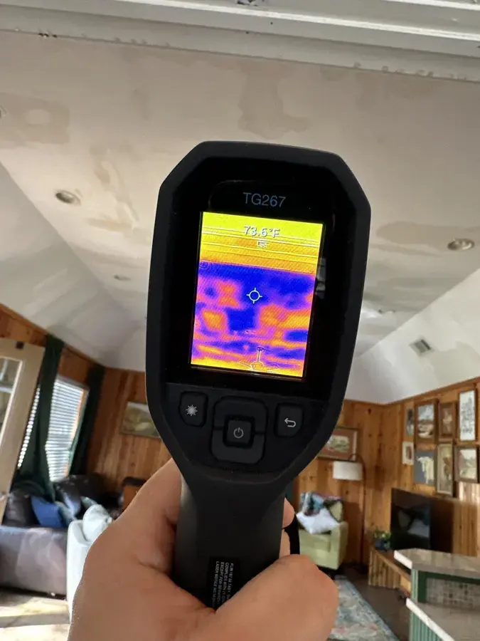 Thermal imaging camera checking a living room for hidden water